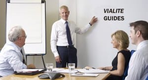 Group shown in learning environment, ViaLite Guides is written on a white board
